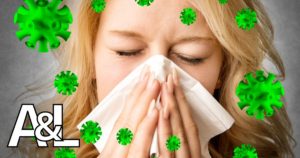woman sneezing into tissue representing air scrubbers
